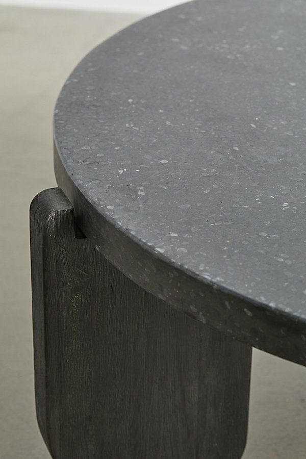 a close up of a black table with a white wall in the background