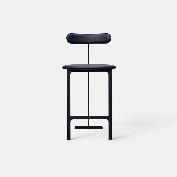 a black stool sitting on top of a white floor