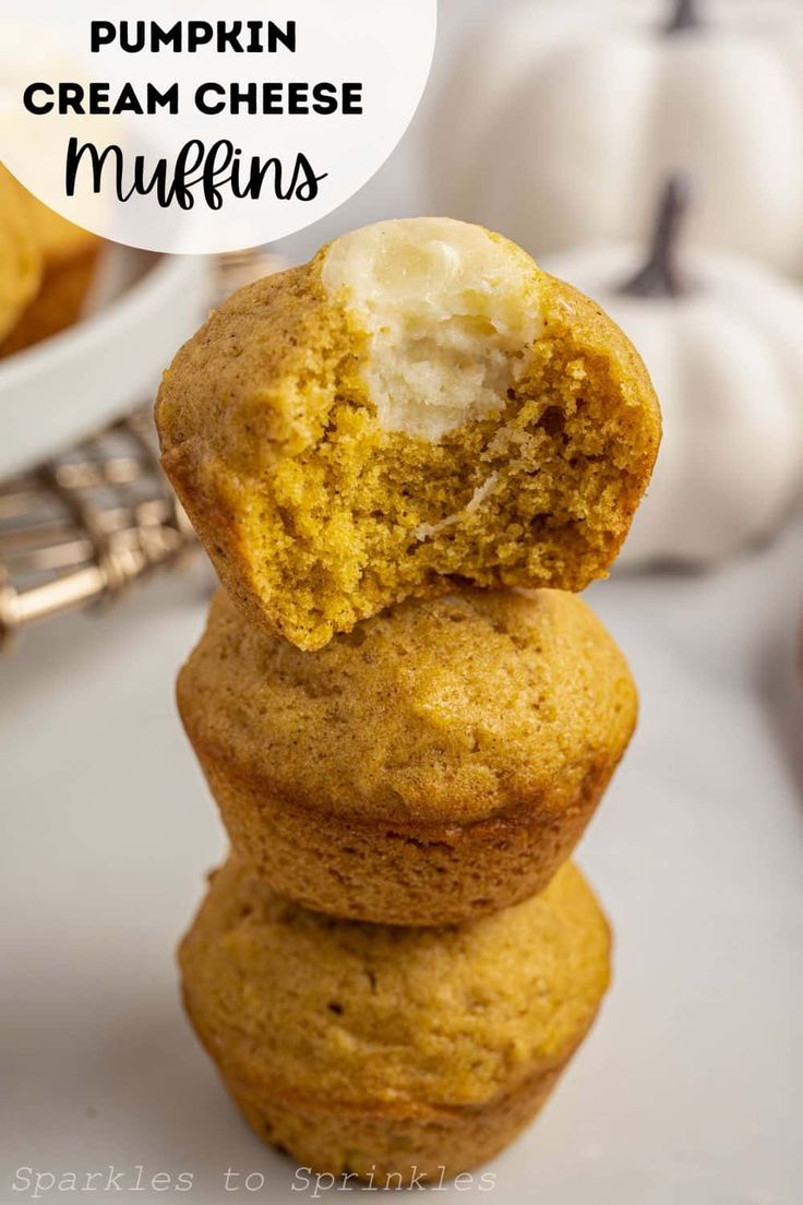 pumpkin cream cheese muffins stacked on top of each other