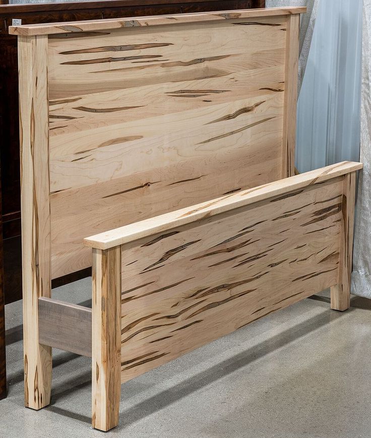 a wooden bed frame sitting on top of a floor