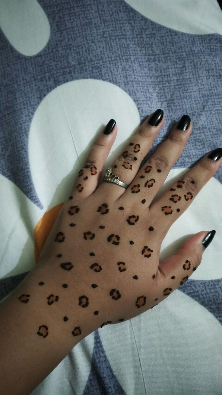 a woman's hand with leopard print on it