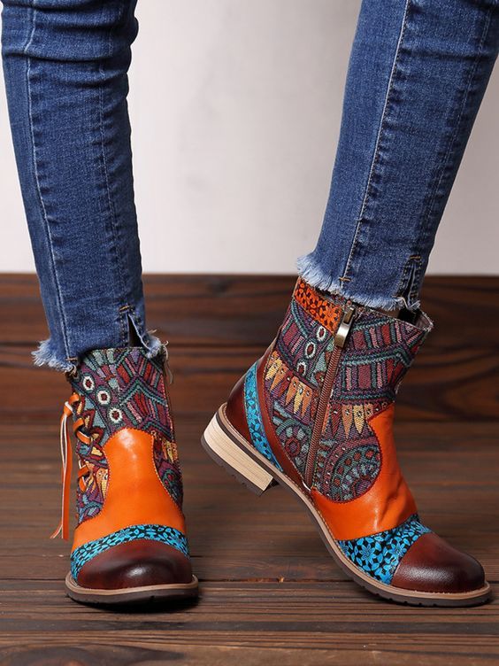 Make an artistic style statement in this durable leather ankle boot embellished with tassel detailed accent at the ankle and a vibrant mix of patterns and colors. 0.78'' heel 3.5" shaft 10.6"  circumference Leather & Canvas upper Cotton floral fabric lining Leather mid-sole Rubber sole Multicolor Ankle-high Boots For Fall, Retro Multicolor Boots For Fall, Multicolor Retro Boots For Fall, Bohemian Ankle-high Boots For Fall, Bohemian Multicolor Boots For Spring, Multicolor Bohemian Boots For Spring, Short Heeled Boots, Floral Boots, Low Heel Boots