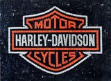 the harley davidson logo is shown in black and orange, with an orange stripe on it