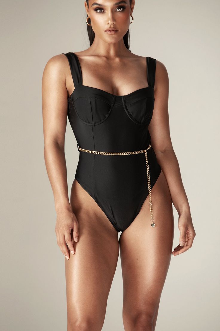 Our 'Timera' swimsuit is minimal but ultra chic and super versatile as it also looks great worn as a bodysuit with a tonal skirt or your favorite denim. Cut from our stretch swim fabric, 'Timera' has supportive underwired cups that are padded for amazing cleavage with simple shoulders straps for the perfect fit. The high rise leg and skimpy back brief, makes 'Timera' super sexy. Wear yours with our ‘Denise bandage skirt’ or ‘Joselyn Vintage fit jeans’ to take you from the beach to sipping cockta Sleek Swimwear With Built-in Bra For Summer, Chic Fitted Bodysuit With Built-in Bra, Chic High Waist Swimwear For Poolside, Chic High-waisted Swimwear For Poolside, High Waist Shapewear Swimwear For Summer, Summer High Waist Shapewear Swimwear, Chic Stretch Bodysuit For Pool, Chic High-waisted Poolside Swimwear, Chic Underwire Bodysuit With Lined Body