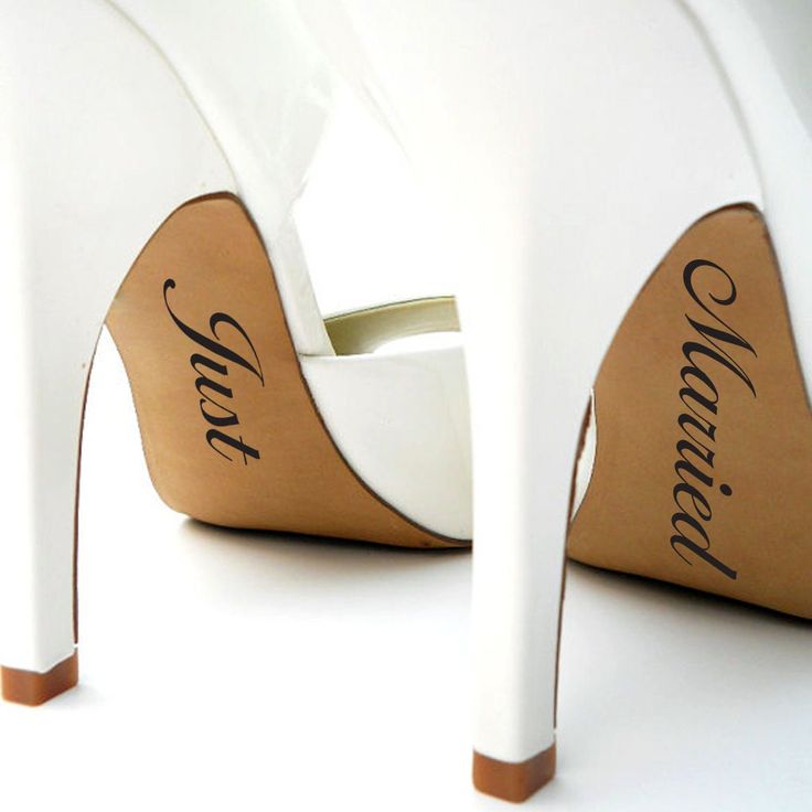 a pair of white high heeled shoes with the word'love'written on them