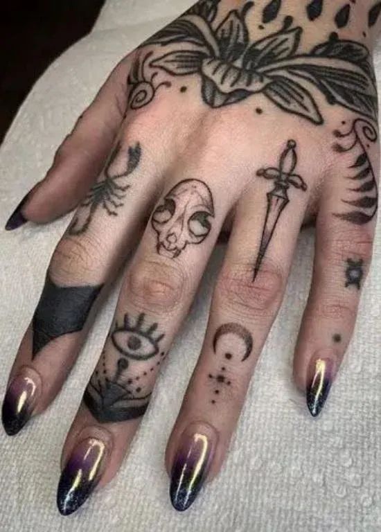 a woman's hand with tattoos on it