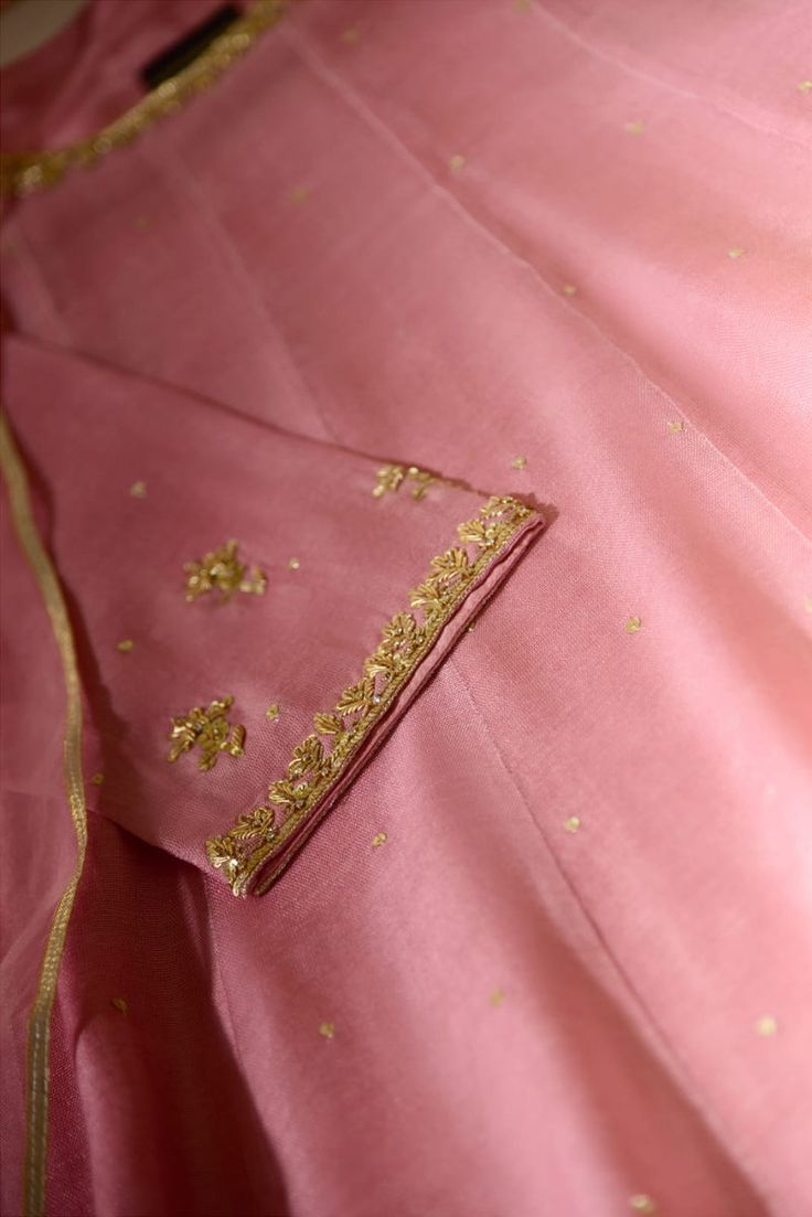 Kiran in adorned on pure cotton net in a tone of blush pink on a panelled pishwas silhouette, perfect to twirl and swirl in, meticulously hand craftmenship in curated on the neckline, hem and border of sleeves, paired with matching dupatta and trousers, making this a crowd favourite. Delivery Date: 6 to 8 weeks Mehndi Dresses, Kurti Neck, Kurti Neck Designs, Abaya Designs, Easy Trendy Outfits, Indian Attire, Pretty Patterns, Saree Blouse, Color Shades