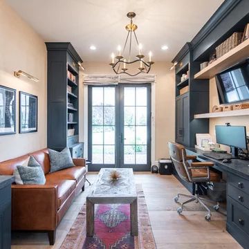 a living room filled with furniture and a flat screen tv mounted to the wall next to a window