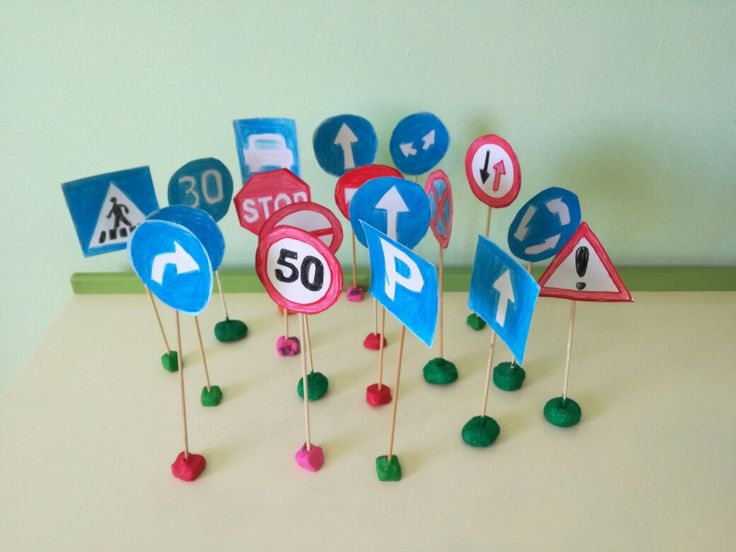 there are many road signs on the table with pinwheels in front of them