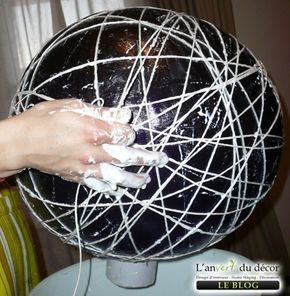 a woman is washing her hands with soap on top of a ball that has wires wrapped around it