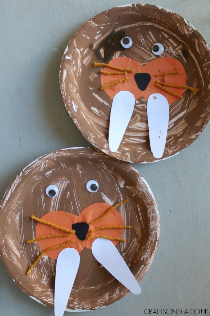 two paper plates with faces made to look like animals