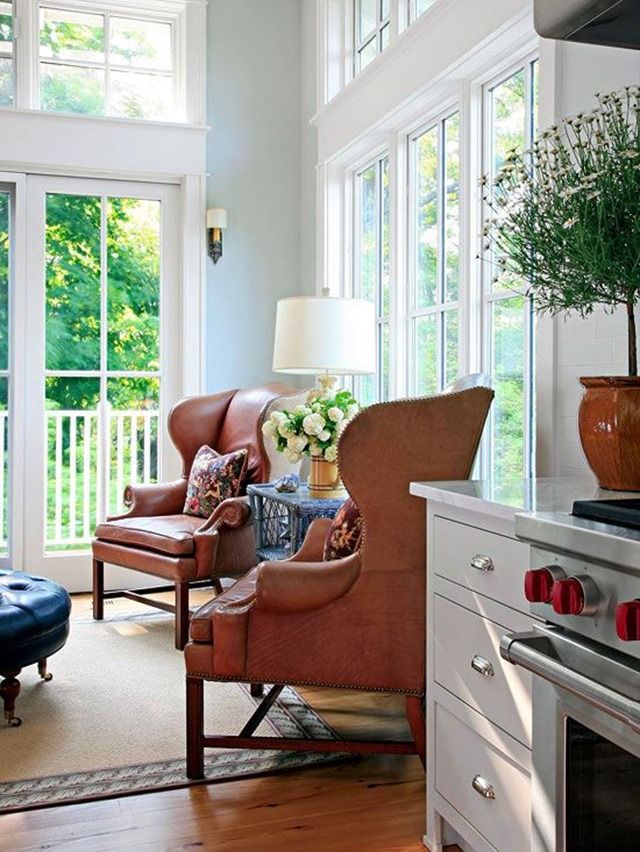 a living room filled with furniture and windows