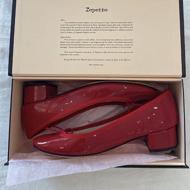 a pair of red shoes in a box