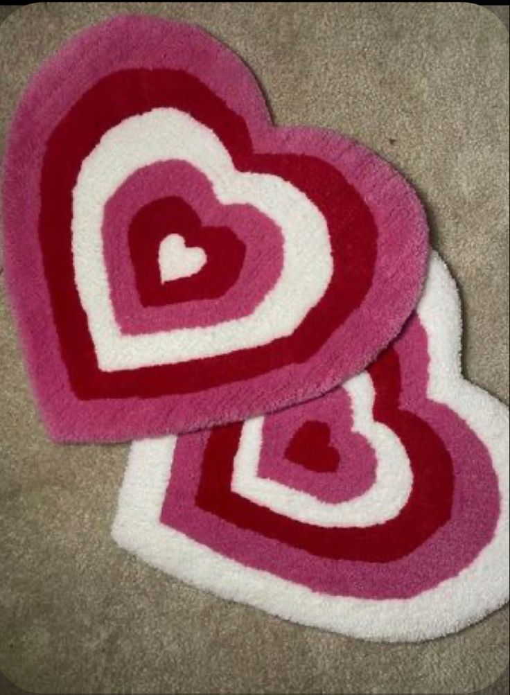 two heart shaped rugs sitting on the floor