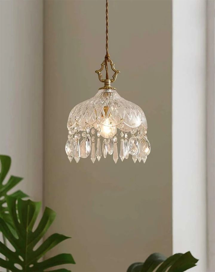 a glass chandelier hanging from a ceiling