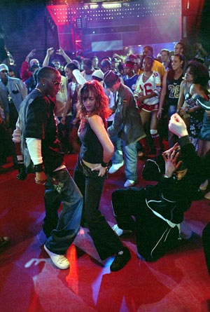 a group of people standing on top of a red carpeted floor next to each other