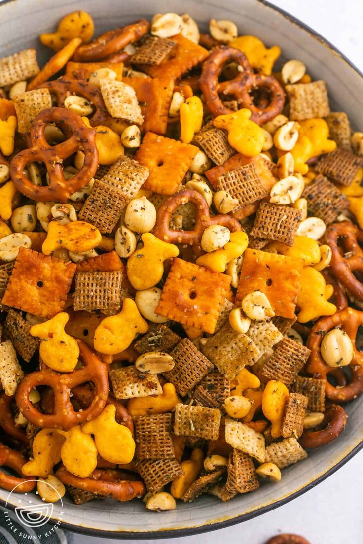 a bowl filled with cheetos and nuts