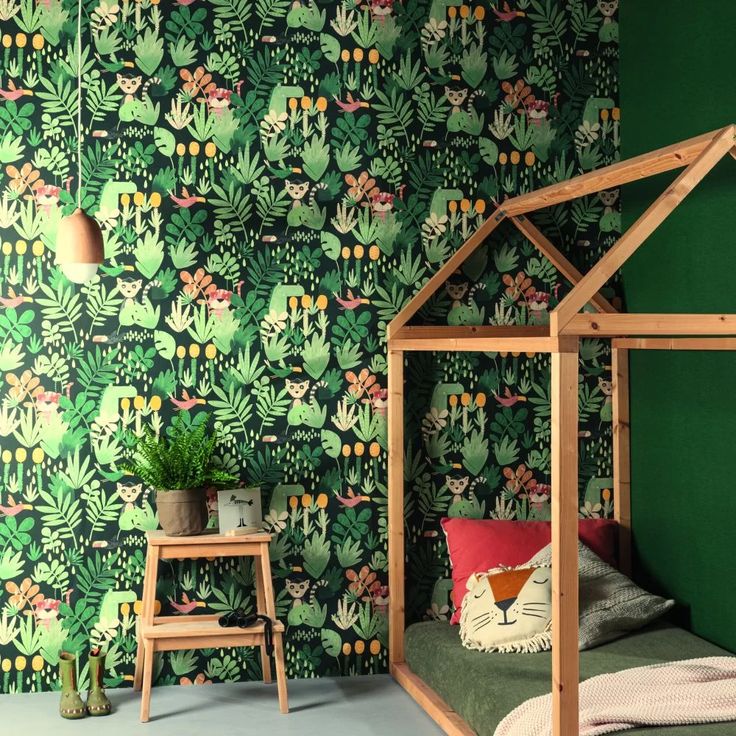 a bedroom with green wallpaper and a wooden bed in front of a plant covered wall