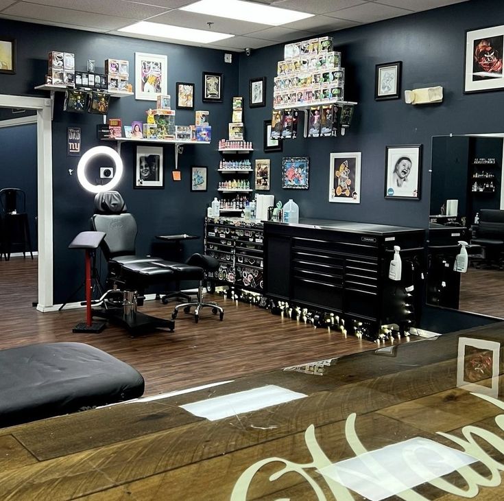 a salon with lots of black furniture and pictures on the wall, including a hair dresser