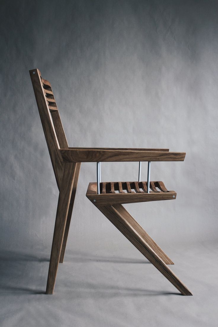 a wooden chair sitting on top of a white floor