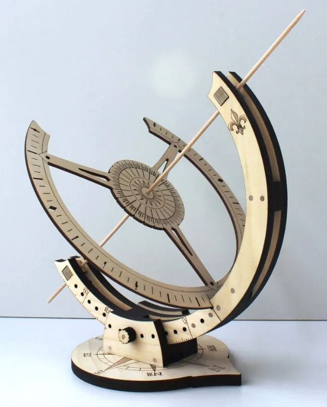 a wooden model of a clock with an arrow on it's side and two arrows in the middle