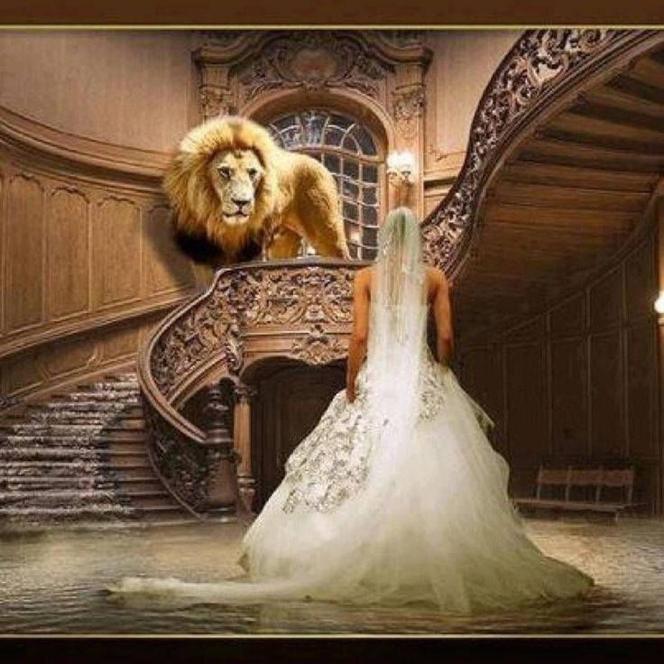 a woman standing in front of a staircase with a lion on it