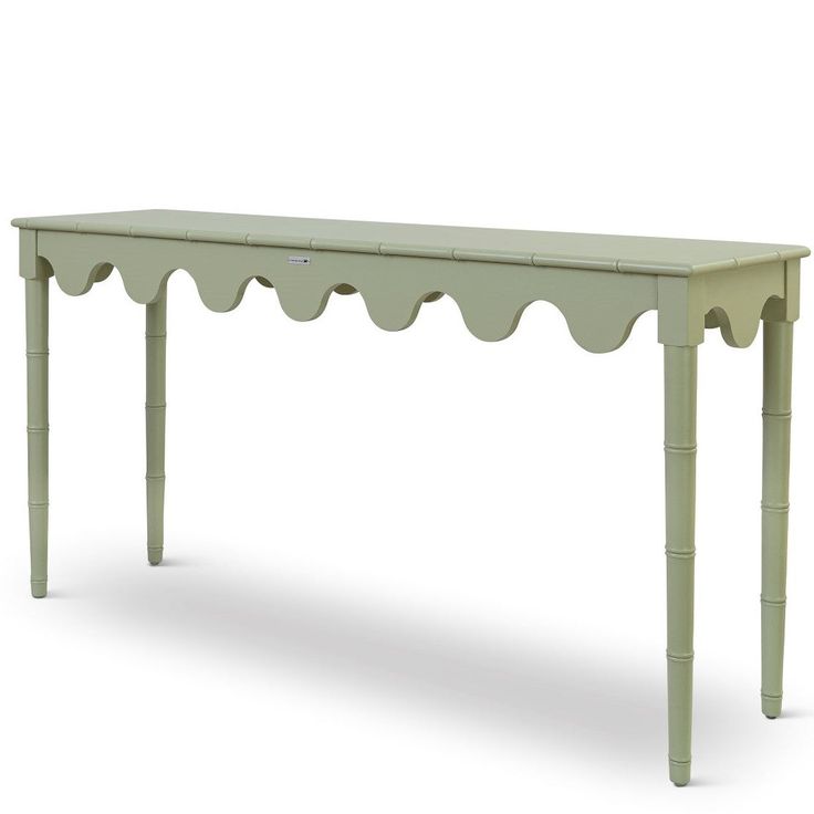 a green table with scalloped legs on an isolated white background