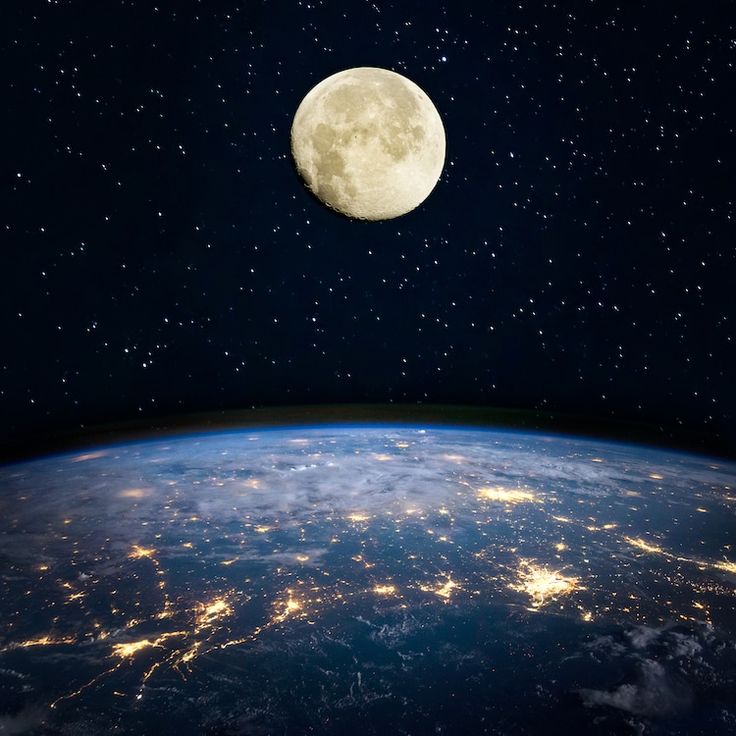 the full moon is seen over the earth at night