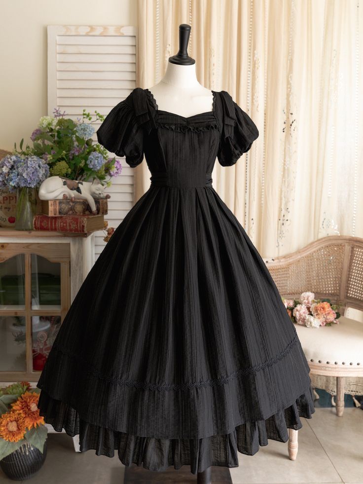 This price includes a dress and a black bowknot hairclip (not for sale).  Embrace timeless elegance with this enchanting Black Puff Sleeves Classic Lolita Princess Tea-Length Dress. Designed for the true Lolita aficionado, this dress features delicately puffed sleeves and a flattering tea-length skirt that exudes sophistication and charm. The back boasts a comfortable shirring detail, ensuring a perfect fit for all body types. Whether you're attending a tea party, a cosplay event, or simply indu Dark Tea Party Outfit, Vintage Dresses 50s 1950s Fashion Classy, Black Dress For Halloween, Vintage Tea Party Outfit, Victorian Black Dress, Black Witchy Dress, Black Princess Dress, Black Peasant Dress, Old Fashioned Dresses