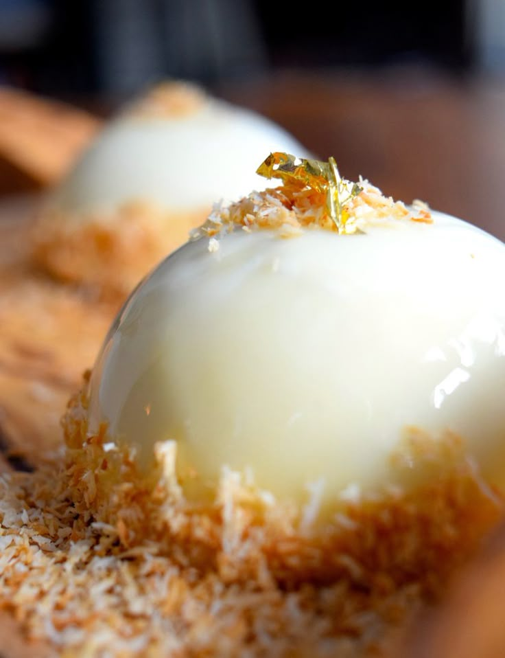 two desserts are sitting on a wooden tray