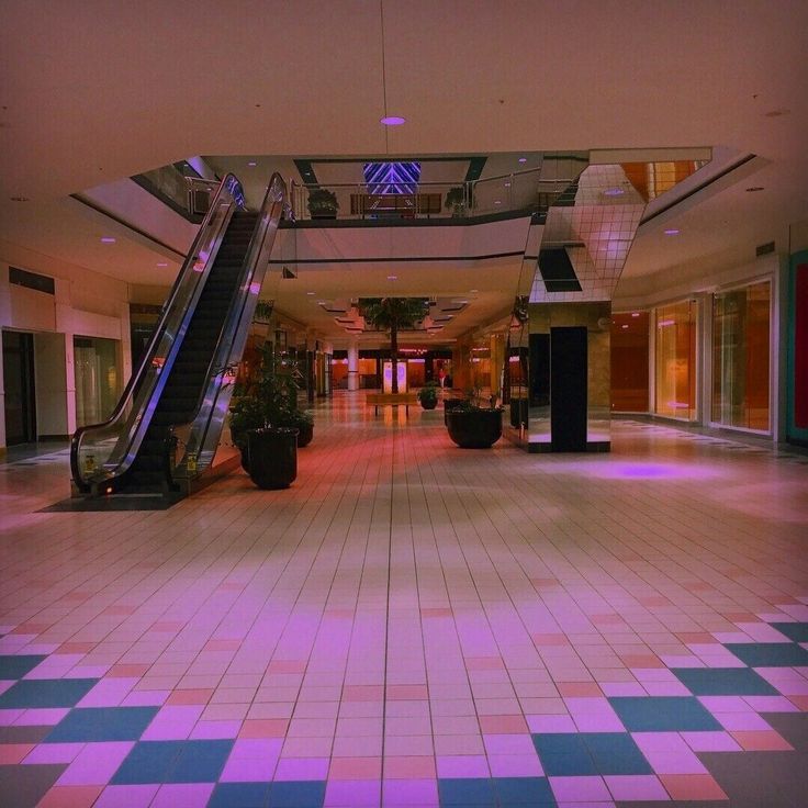 an escalator in the middle of a large building with tiled floors and walls