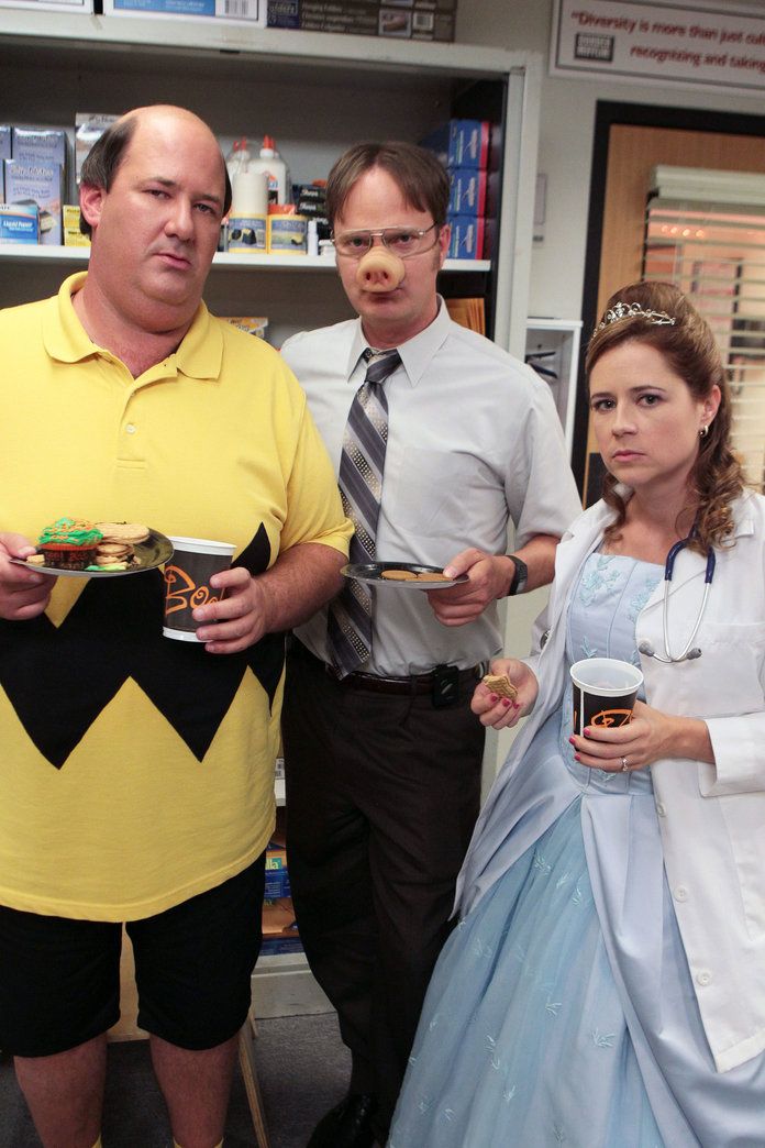 three people dressed up in costumes posing for a photo with one person holding a plate