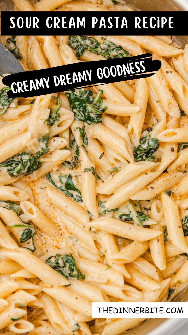 pasta with cream sauce and spinach in a pan