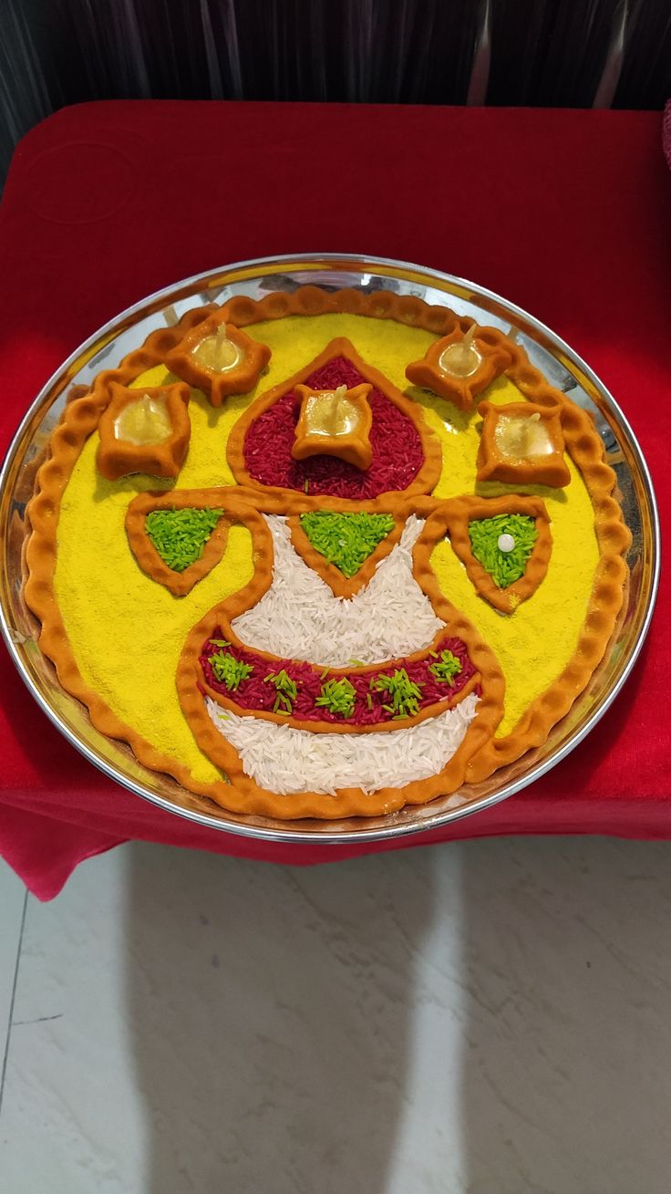 a plate with some food on it sitting on a red table cloth next to a vase