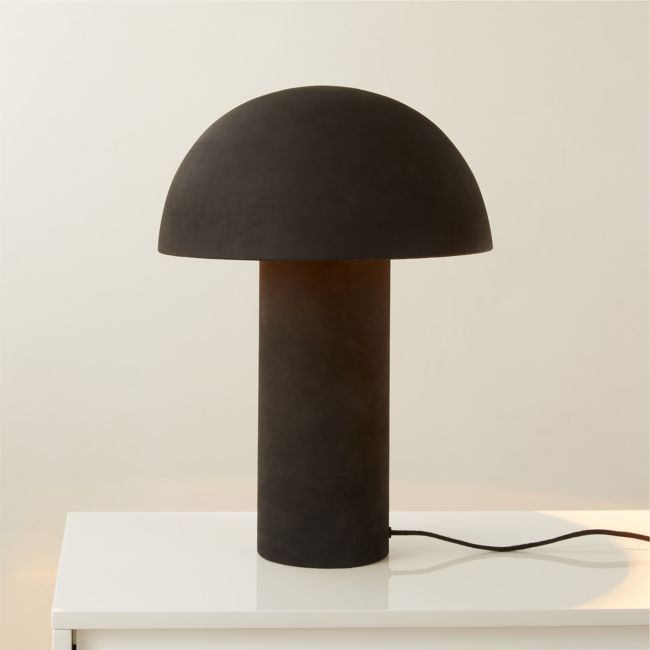 a black lamp sitting on top of a white table