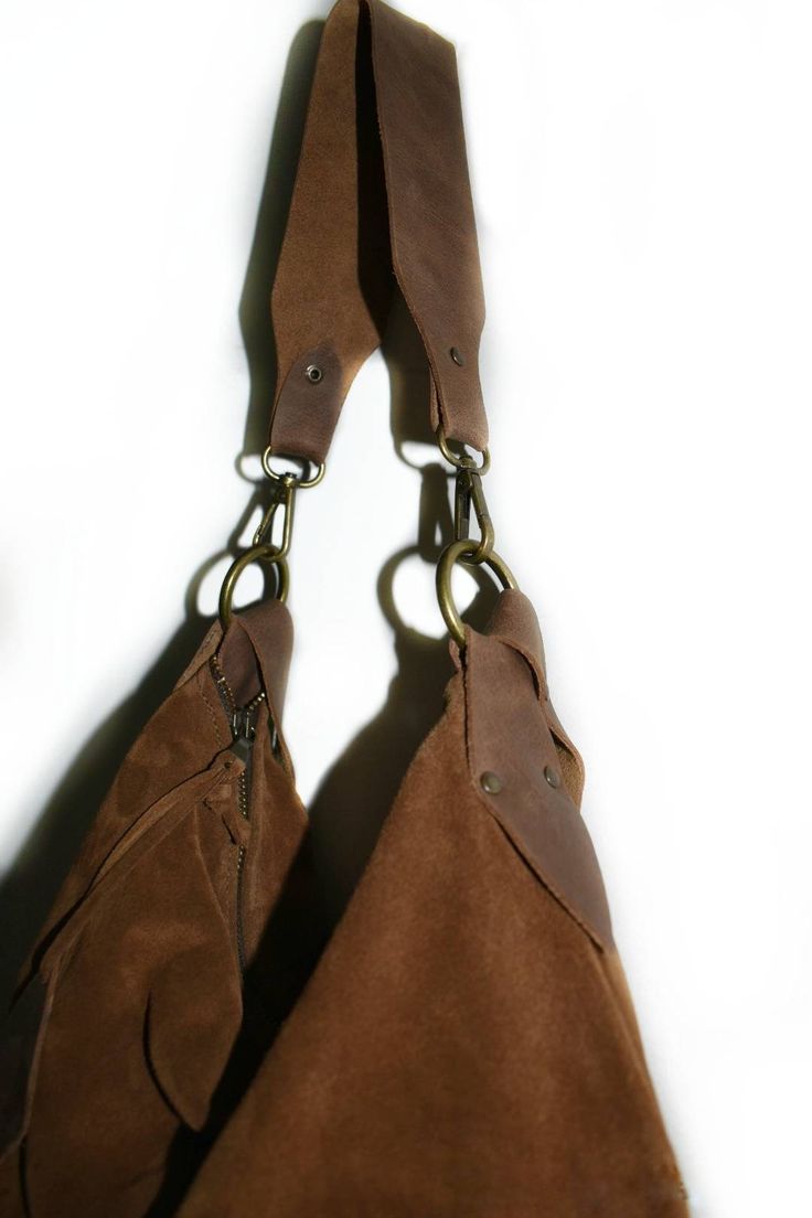 a brown leather purse with metal chains hanging from it