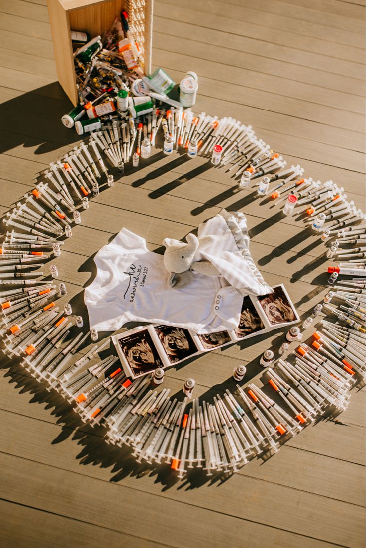 an assortment of bottles and t - shirts are arranged in a circle on the floor