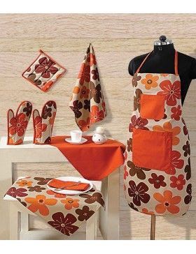 an orange and brown floral print kitchen set with matching table cloths, utensils and napkins