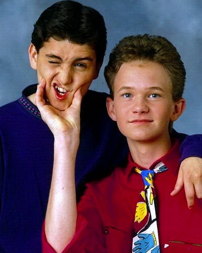 two boys are posing for a photo together