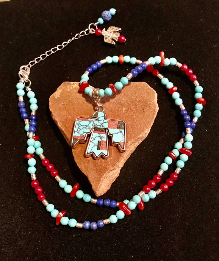 Southwest Tribal Gemstone Necklace can also be used for Aromatherapy. The Lava Bead in the necklace extender is an Essential Oil Diffuser. A free Oil Sample of Liquid Sunshine is included. These are the Beads in this Necklace Design.  4mm Dark Blue Turquoise  4mm Blue Howlite   4mm Red Coral  Small Chip Red Coral  6mm Blue Lava Bead(Essential Oil Diffuser)  Silver Spacer Beads and Phoenix Charm  Tribal Phoenix Pendant   2" Bracelet Extender This Necklace will arrive in a Turquoise Gift Box with Adjustable Blue Turquoise Southwestern Necklace, Southwestern Turquoise Adjustable Necklace, Southwestern Turquoise Beaded Necklace For Gift, Southwestern Turquoise Beaded Necklace As Gift, Turquoise Southwestern Beaded Necklace Gift, Turquoise Southwestern Beaded Necklace For Gift, Handmade Southwestern Blue Beaded Necklace, Multicolor Hand-strung Turquoise Necklace Gift, Bohemian Blue Heart Beads