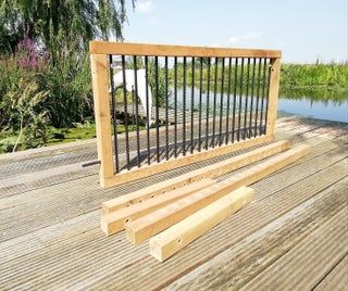 a wooden bench sitting on top of a wooden deck next to a body of water