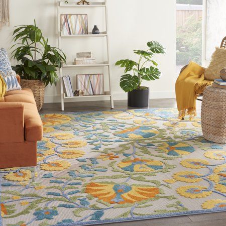 a living room filled with lots of furniture and rugs on top of a wooden floor