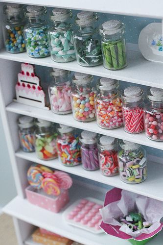 a shelf filled with lots of candy on top of it's shelves next to other items