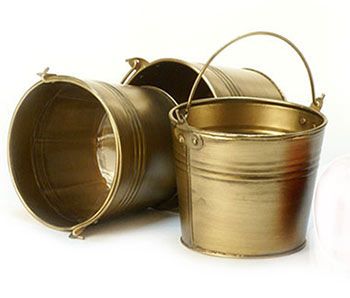 three metal buckets and an apple on a white background