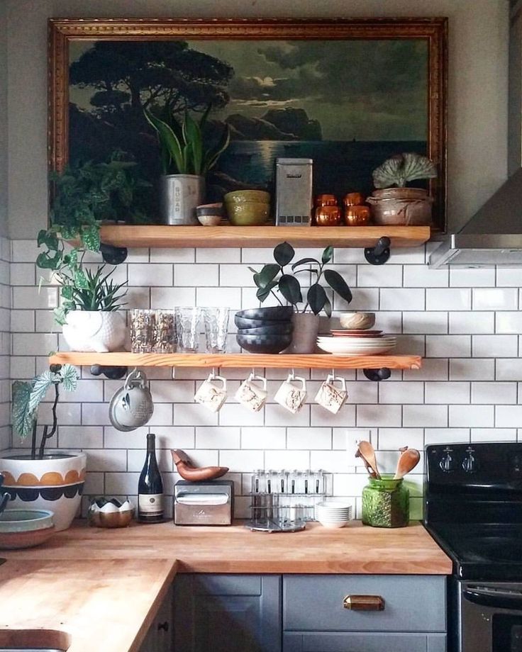 the kitchen is clean and ready for us to use it's shelves are filled with dishes