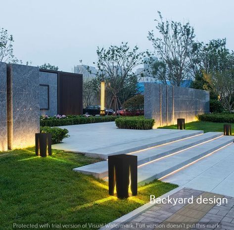 an outdoor area with steps, bushes and lights