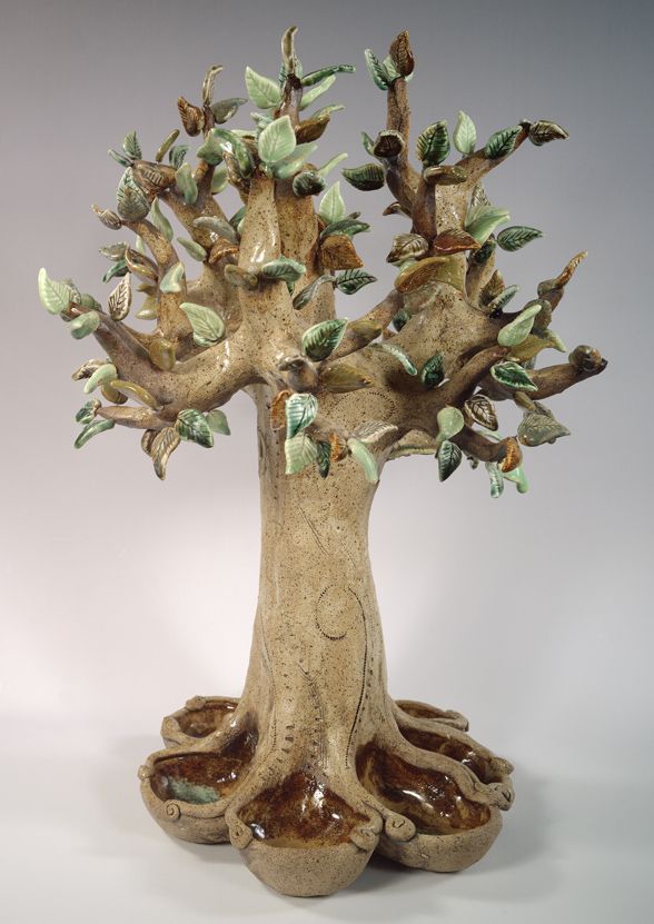 a ceramic sculpture of a tree with lots of leaves