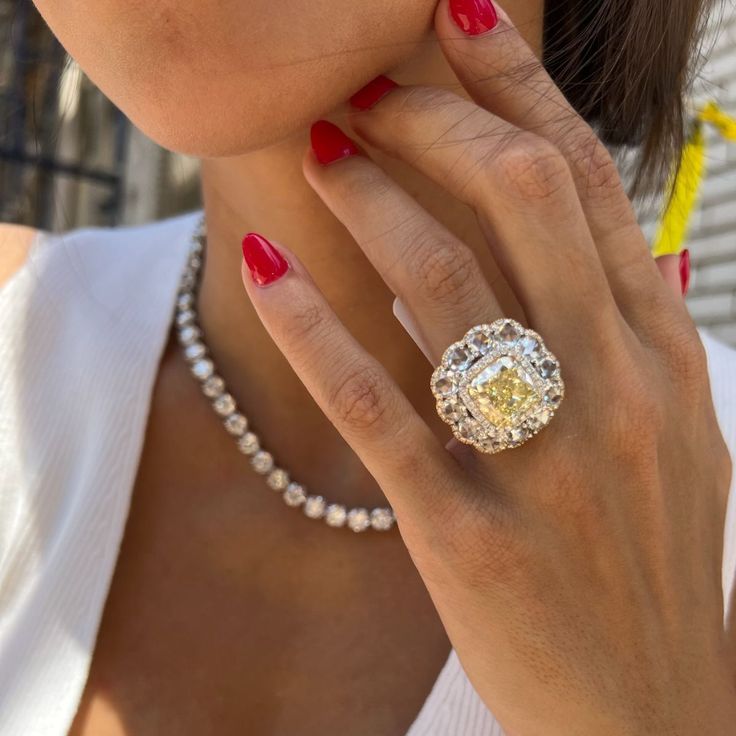 a close up of a person wearing a diamond ring