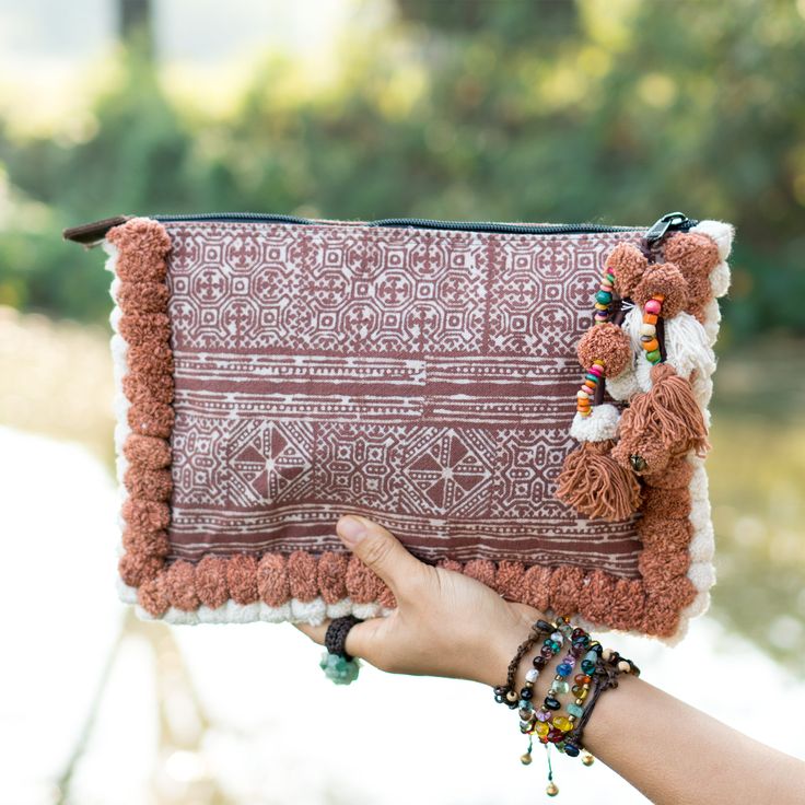 "This beautiful Bag was made by the HMONG hill tribes of Lanna Country (Northern Thailand). It features the edge of bag with two tone pom pom. This bag is zipper closure and one zippered pocket inside. We buy materials from Hmong market and we design and sew by hand. Some of the bags we modify to improve the product. The Hmong tribes live in the North of Thailand and have origins from the Tibetan area of China. Approx Measurement Length: 12\" inches, 30 cm Height: 8\" inches, 20 cm Shipping Orde Bohemian Rectangular Clutch With Tassels, Handheld Woven Bohemian Shoulder Bag, Bohemian Woven Handheld Shoulder Bag, Bohemian Woven Clutch Shoulder Bag, Bohemian Rectangular Pouch, Bohemian Woven Pouch Clutch, Bohemian Clutch Bag With Tassels, Bohemian Tassel Clutch Bag, Bohemian Clutch Shoulder Bag With Tassels