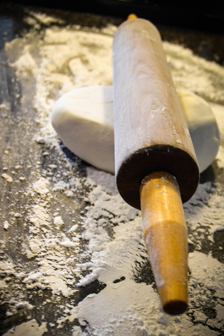 a rolling pin sitting on top of flour